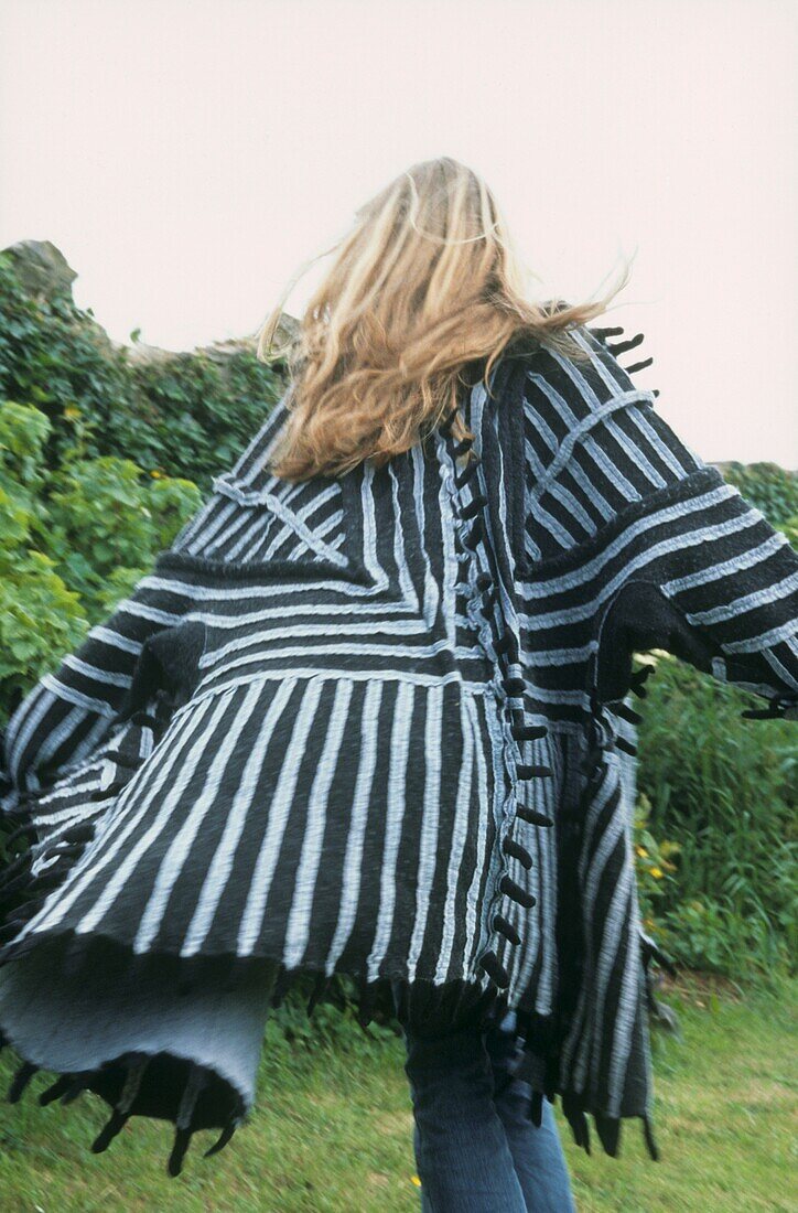 Back view of woman in black and white felt coat