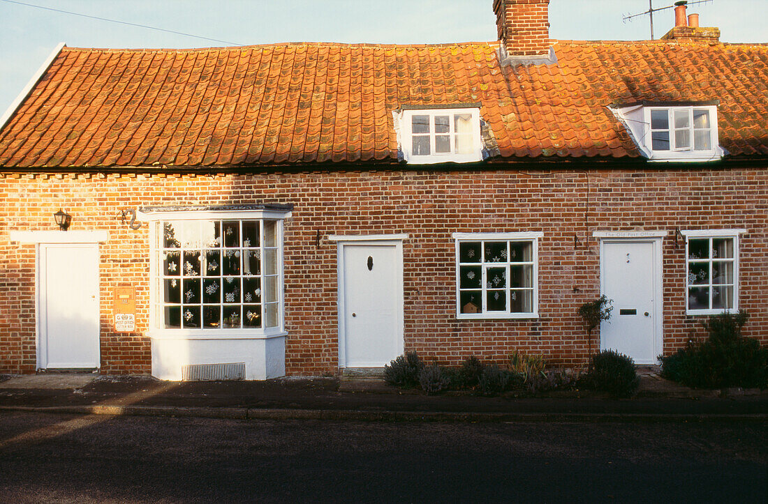 Bay windows and brick work of Old Post Office with pantile roof and chimney