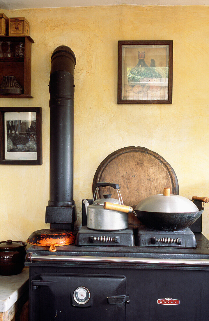 Kettle and wok on old fashioned stove of Edwardian brick cottage