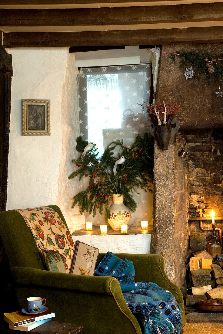 Vintage armchair beside the fire with candles