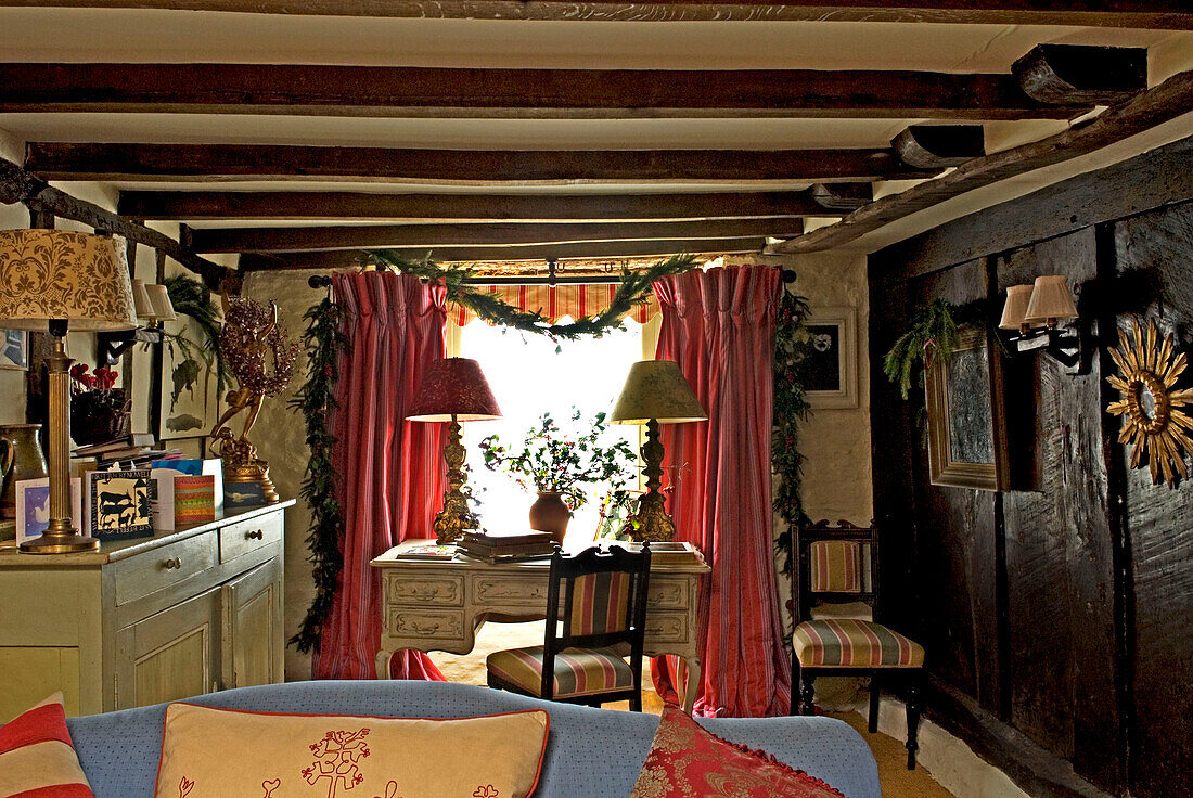 View to window and desk in living room decorated for christmas