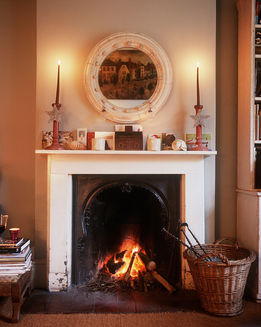 Christmas cards and decorations on shelf above fireplace