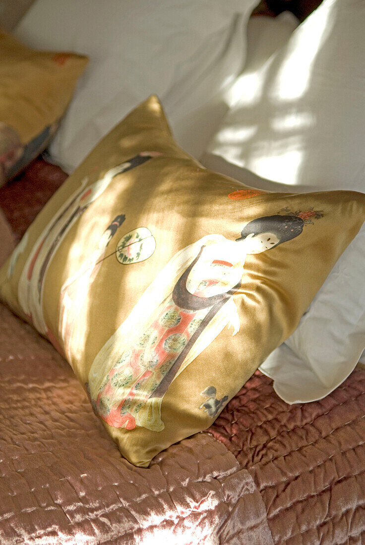 Decorative pillow on double bed close-up