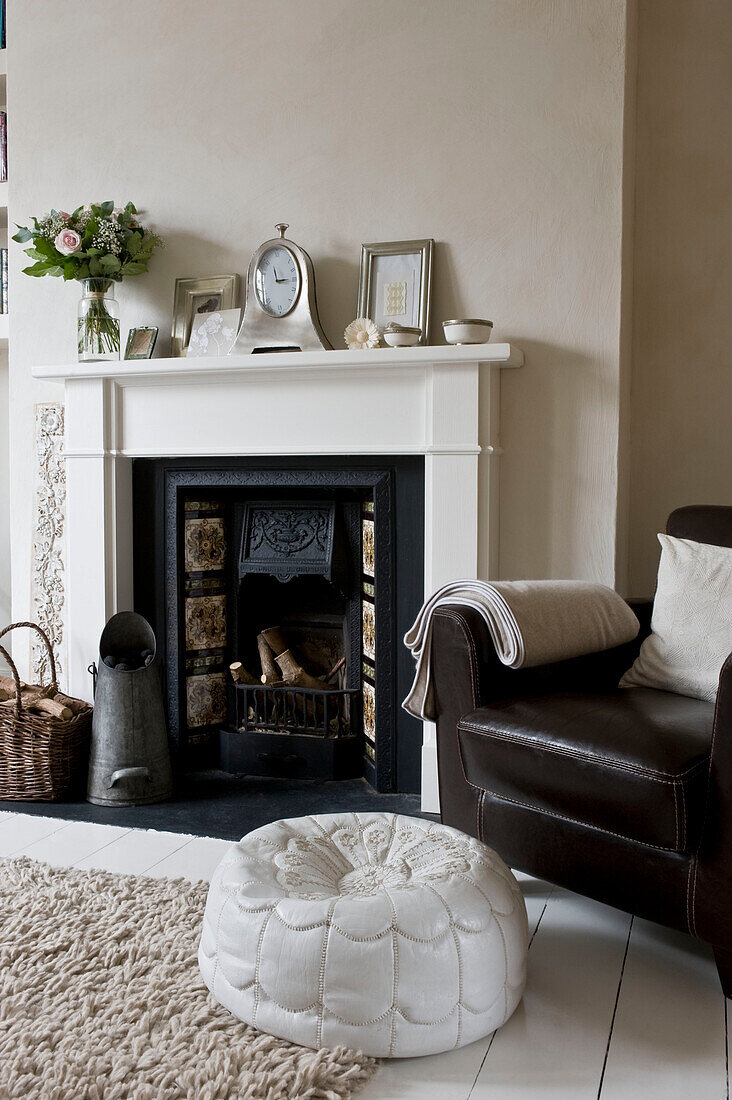 Armchair by fireplace in living room