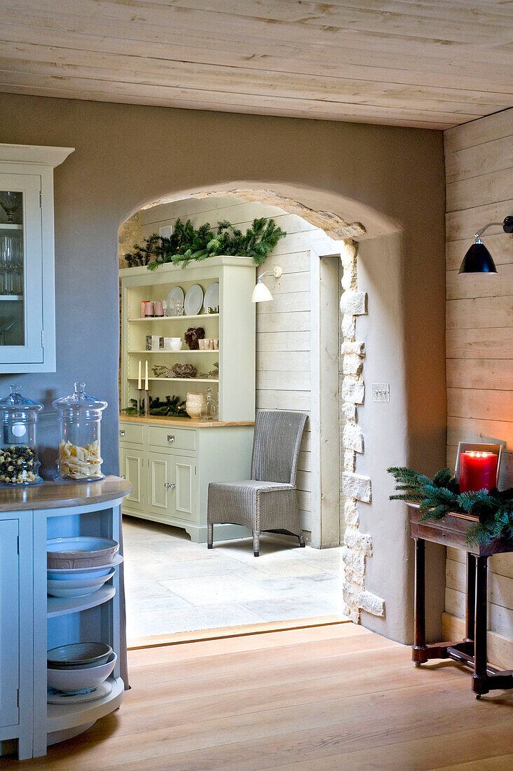 View of kitchen dresser through archway of Wiltshire farmhouse