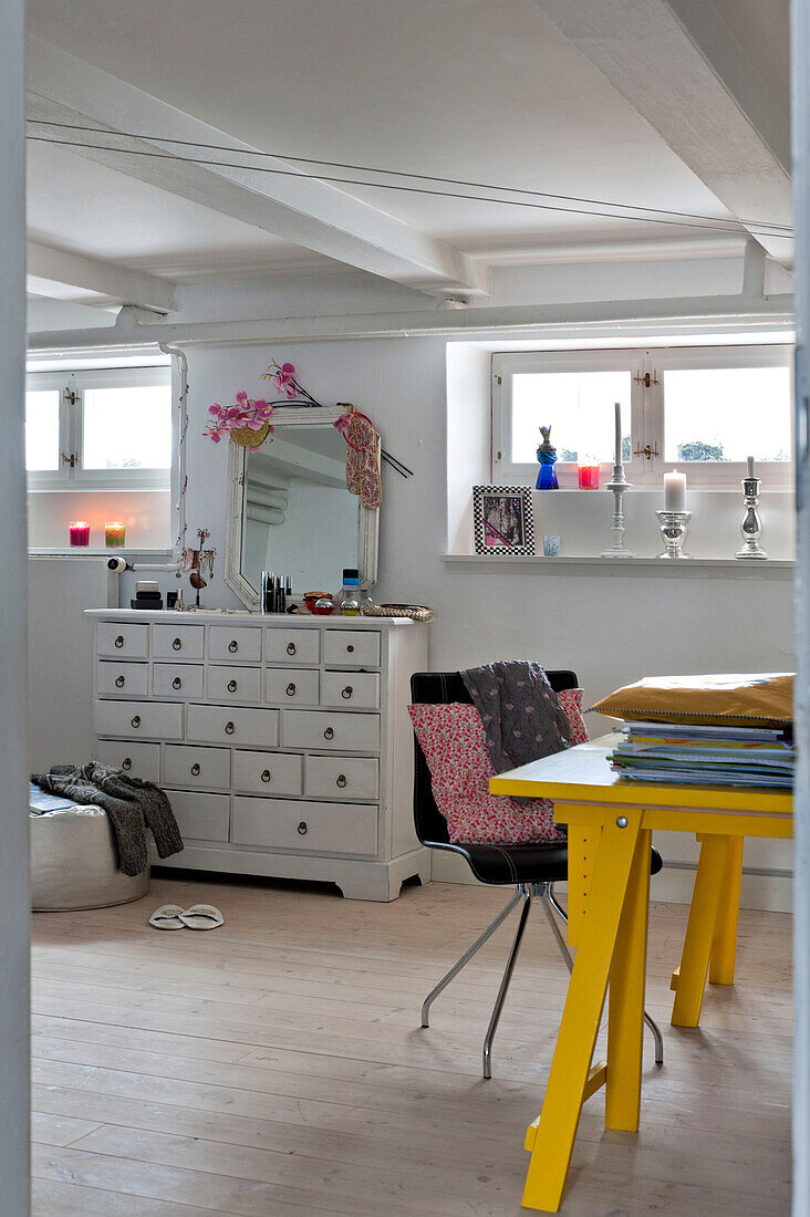 Yellow work table and drawer unit in modern Odense bedroom Denmark