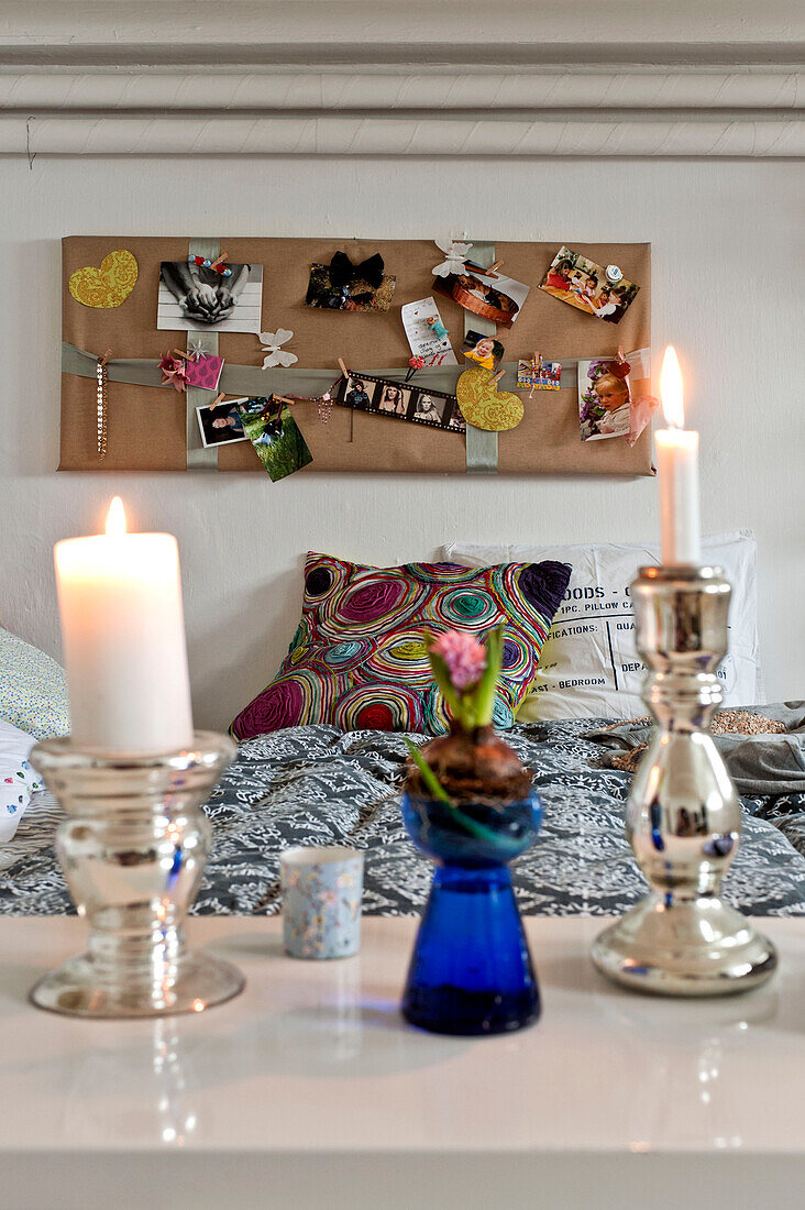 Lit candles and pinboard in bedroom of modern Odense bedroom Denmark