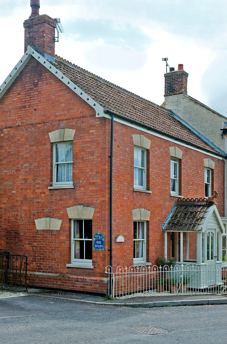 Traditional brick corner house end of terrace UK