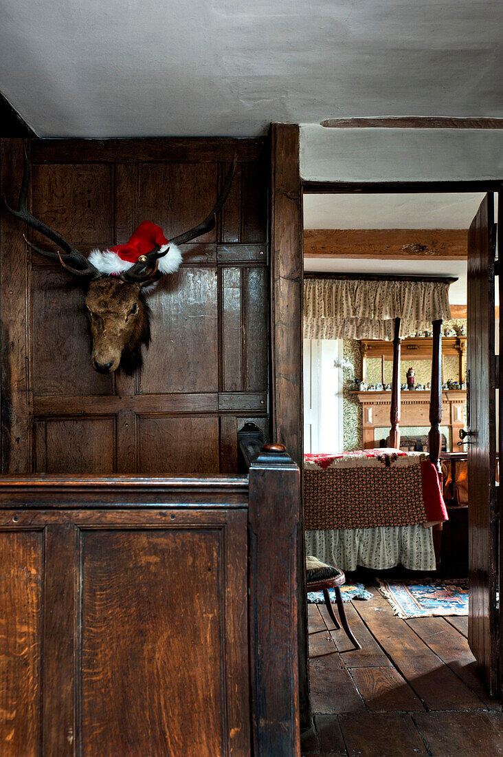 View through doorway with hunting trophy to bedroom of Cheltenham country home Gloucestershire England UK