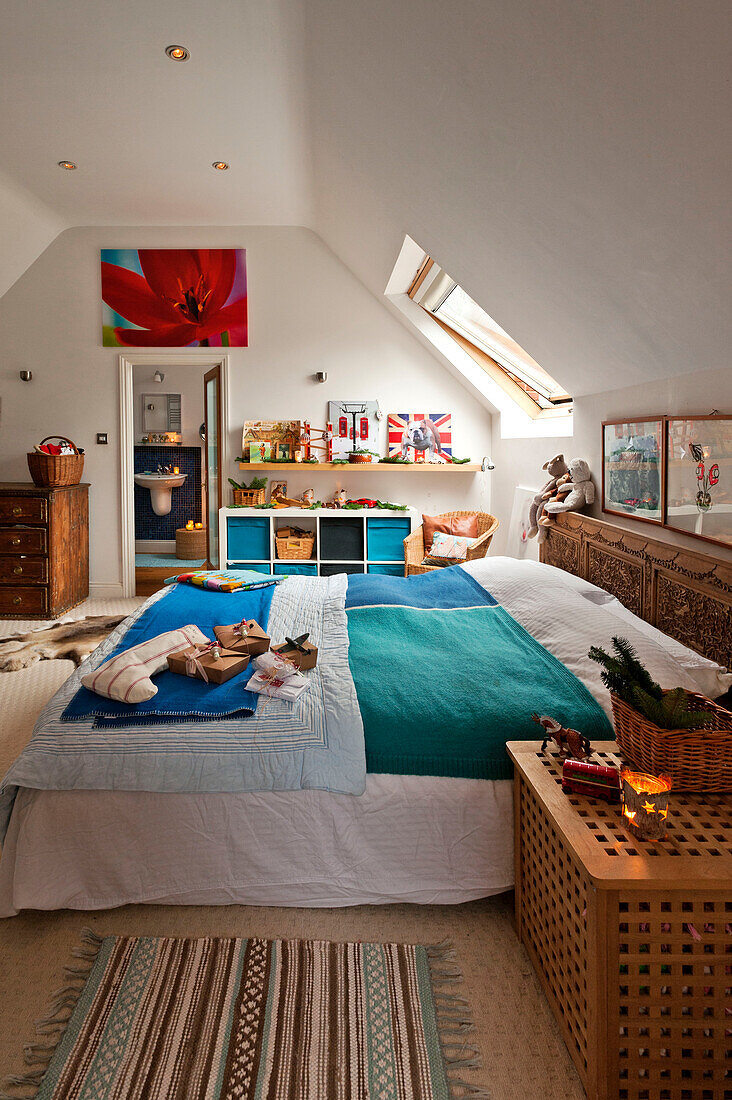 Gift wrapped presents in attic bedroom of Forest Row family home, Sussex, England, UK