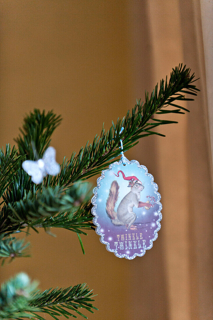 Christmas tree ornament on pine tree branch in Forest Row family home, Sussex, England, UK