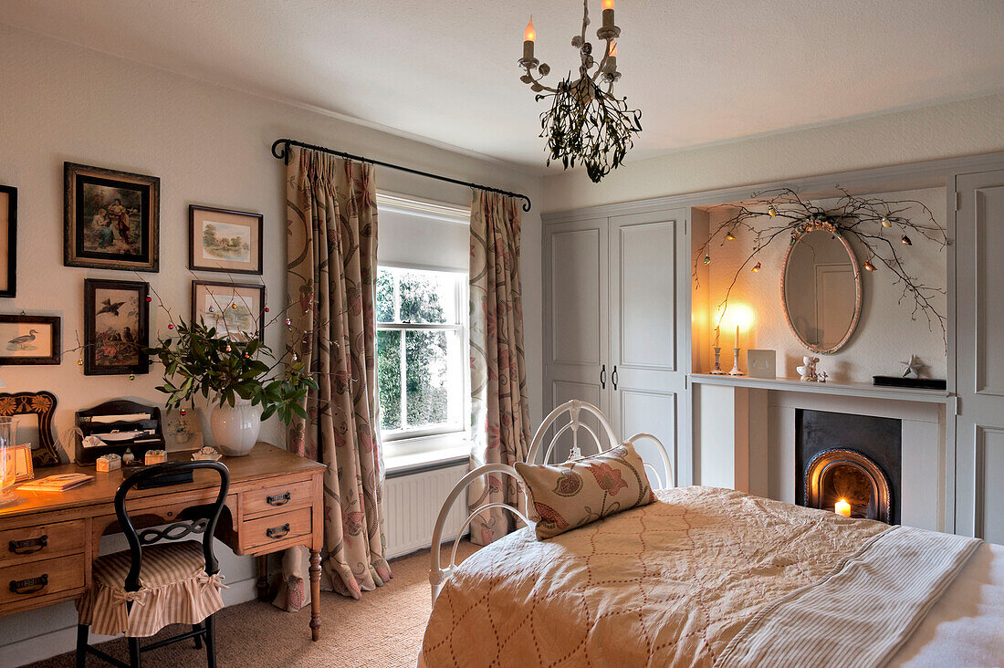 Lit candles in country styled bedroom of Walberton home, West Sussex, England, UK