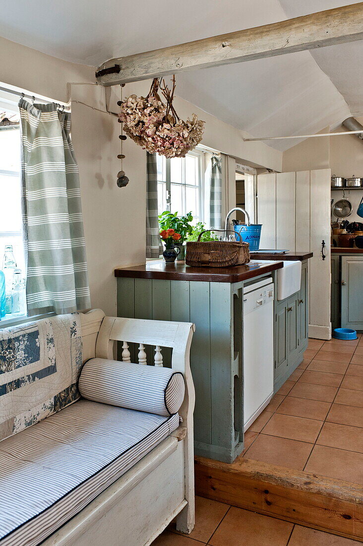 Bench seat in split level kitchen of Suffolk farmhouse, England, UK