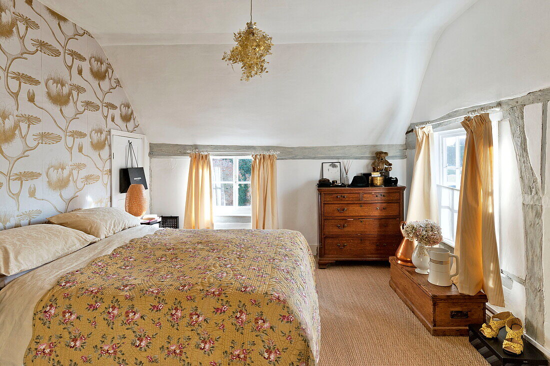 Contrasting prints in Suffolk farmhouse bedroom, England, UK