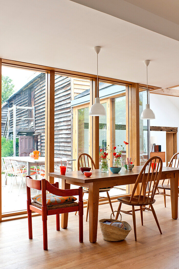 Table and chairs in contemporary Hertfordshire family home, England, UK