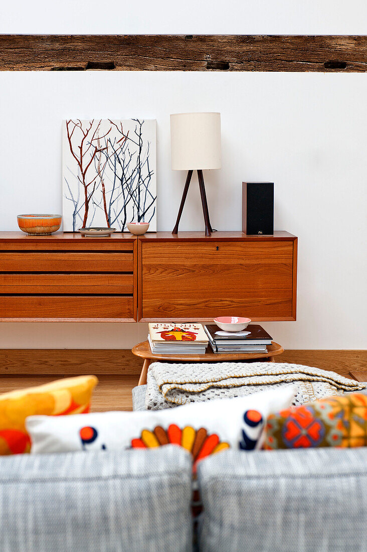 Vintage sideboard with artwork in living room of Hertfordshire family home, England, UK