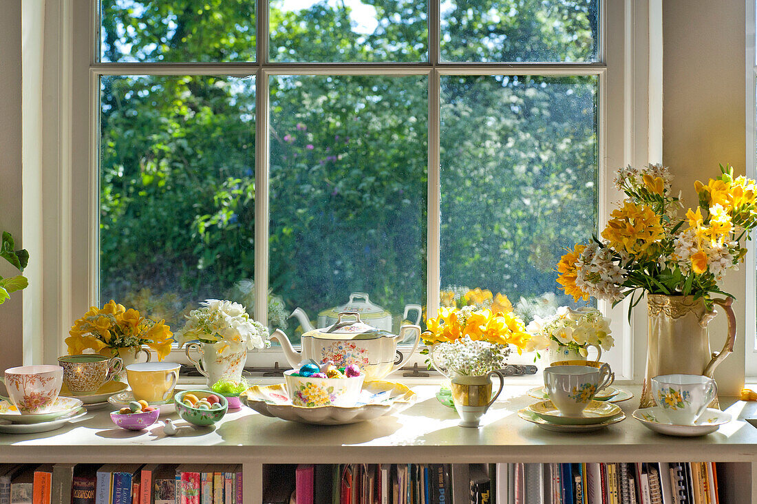 Easter eggs and crockery on sunlit windowsill of Essex home, England, UK