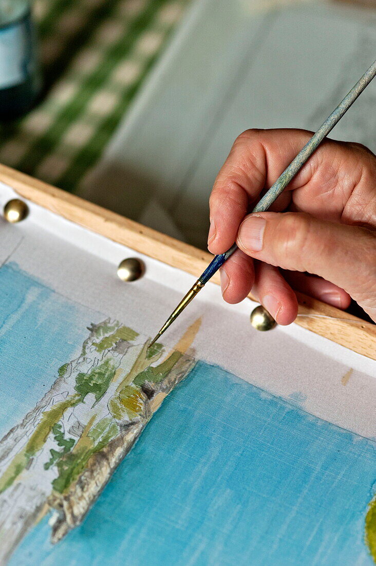 Woman working on Cornish seascape in Padstow, Cornwall, England, UK