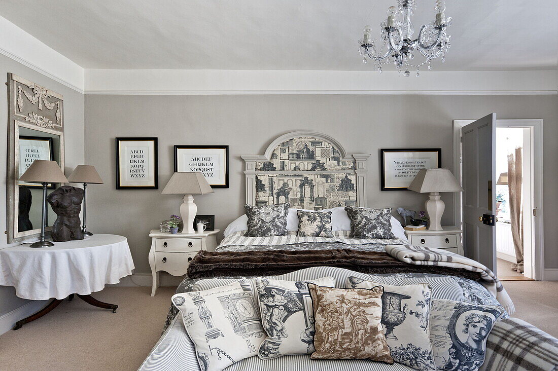 Patterned cushion fabrics and artwork in bedroom of Bury St Edmunds country home, Suffolk, England, UK