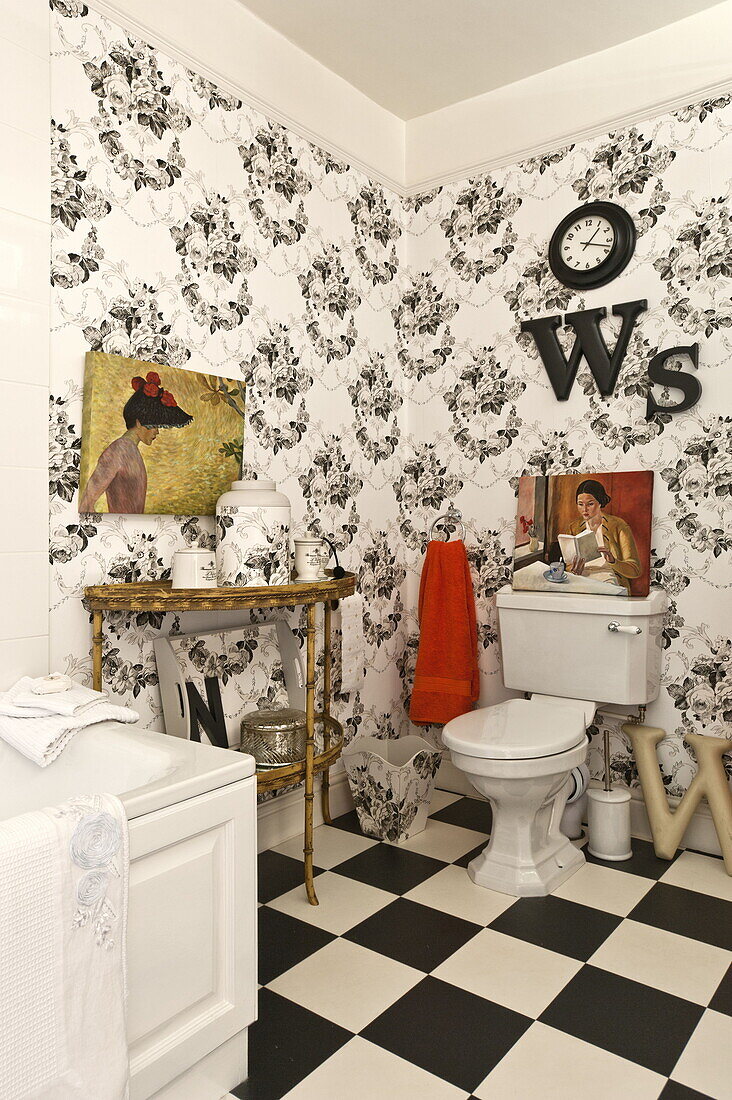 Black and white bathroom with art canvas in Bury St Edmunds country home, Suffolk, England, UK