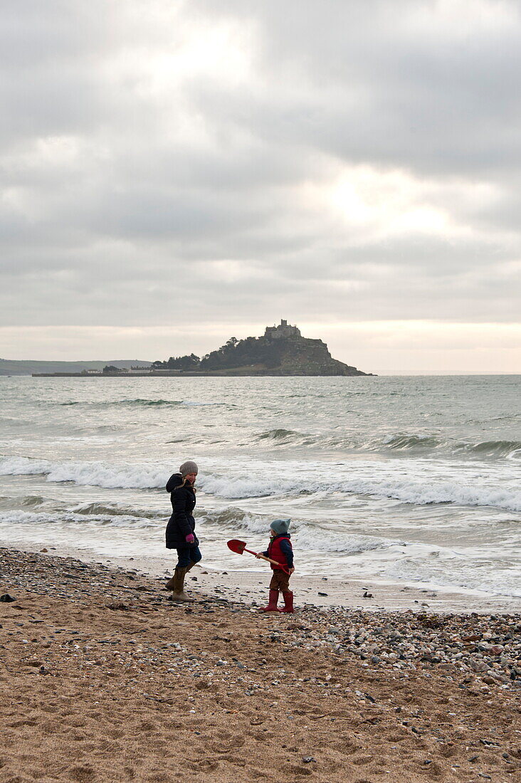 Mother and son walking on beach Penzance Cornwall England UK