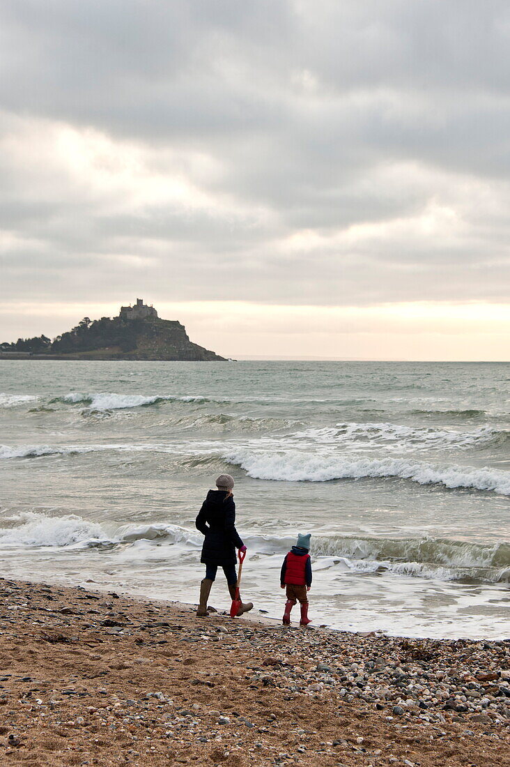 Mother and son walking on beach Penzance Cornwall England UK