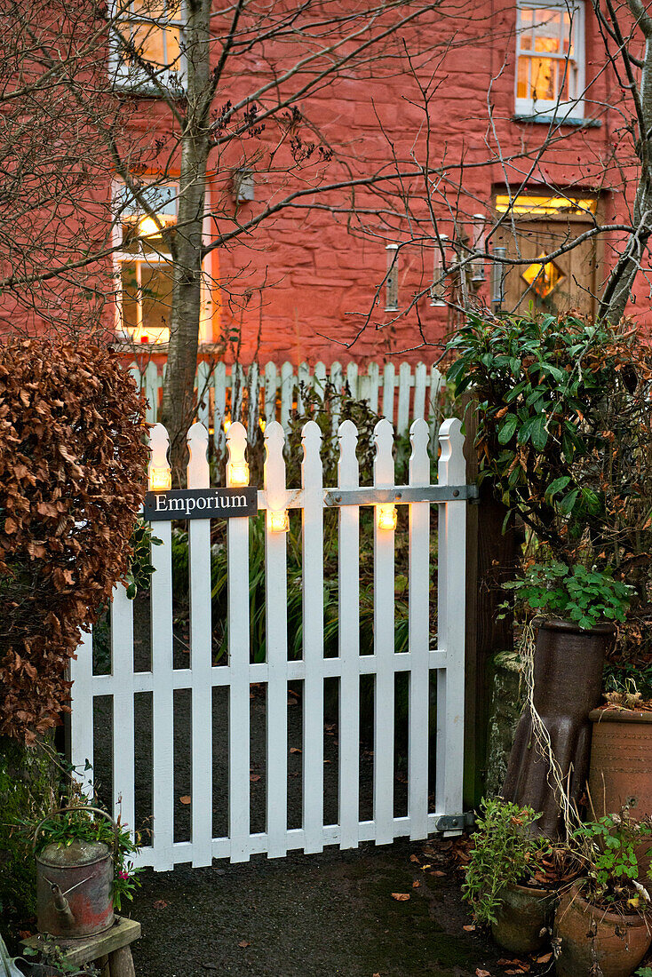 White gate at brick exterior of rural country house Tregaron Wales UK