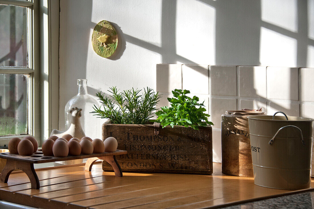 Vintage crate and egg rack in sunlit kitchen of Sherford barn conversion Devon UK