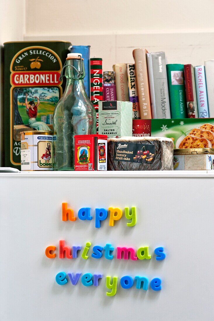 Magnets and recipe books on upright fridge in Penzance family home Cornwall England UK