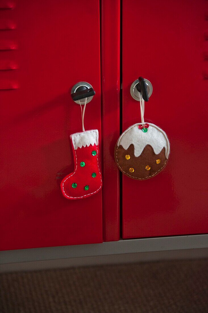 Handmade Christmas ornaments on red cupboard in Penzance family home Cornwall England UK