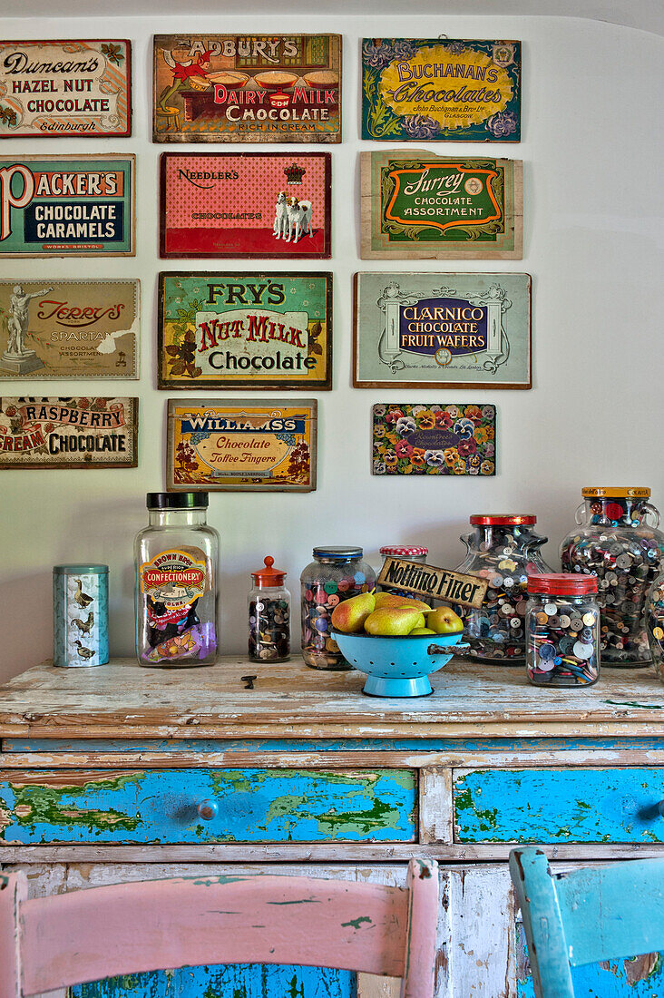 Vintage advertising and sweet jars on sideboard in Cambridge cottage England UK