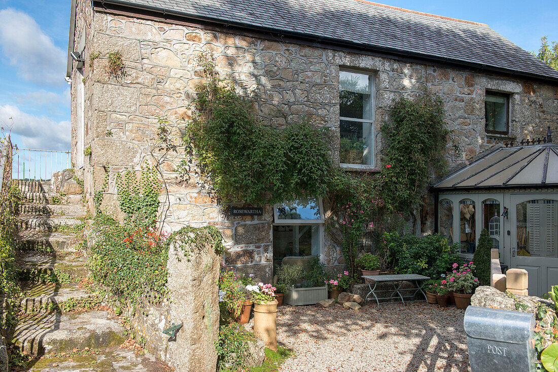 Sunlit courtyard garden of detached stone house in Penzance Cornwall UK