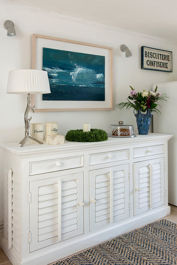 Artwork of seascape above sideboard in Penzance farmhouse Cornwall England UK