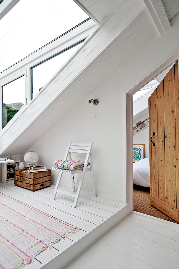 Aplit-level attic conversion with open wooden door in family townhouse Cornwall England UK