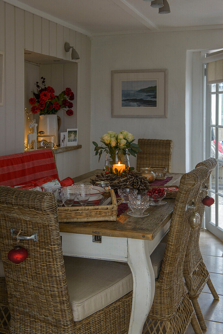 Wicker chairs at dining table at Christmas in Penzance farmhouse Cornwall UK