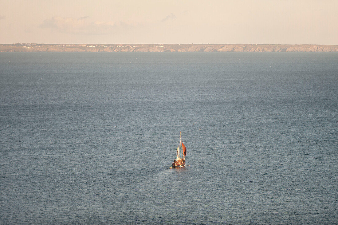 Sailing boat moving across Mount's Bay Penzance Cornwall UK