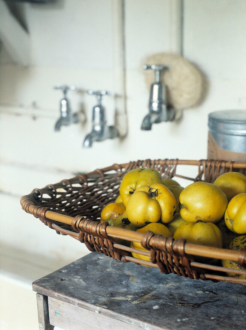 Quinces in woven basket by sink