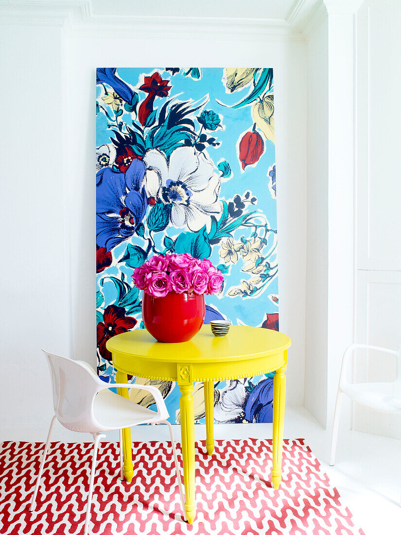 Vase of flowers on yellow table with floral art canvas