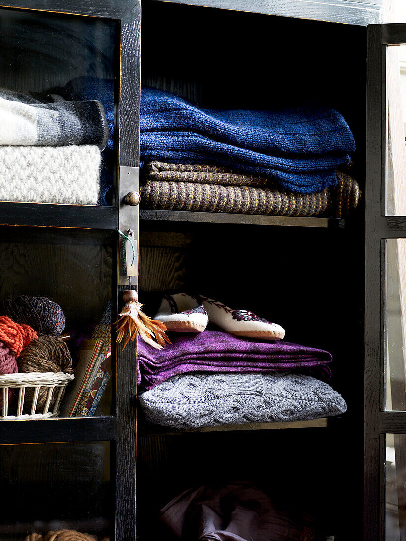 Cabinet with woollen blankets and wool