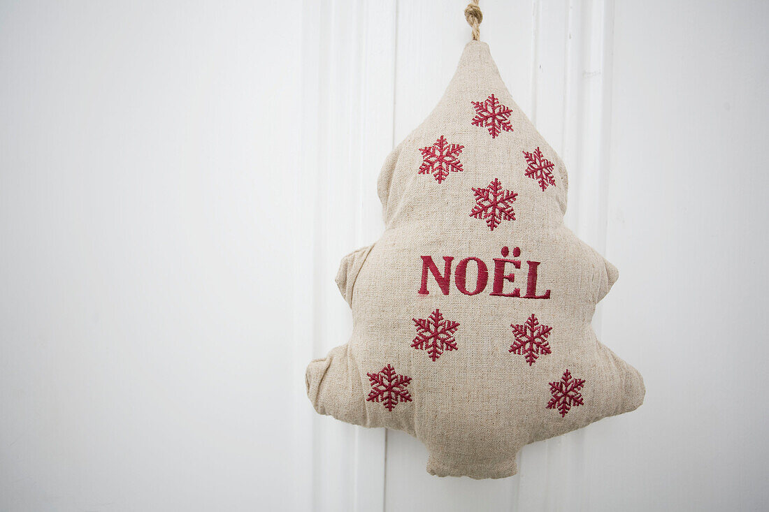 Christmas decoration in shape of tree with single word 'noel in Tenterden family home, Kent, England, UK