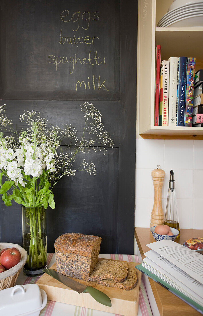 Blackboard with cut flowers and fresh bread in Deal home Kent England UK