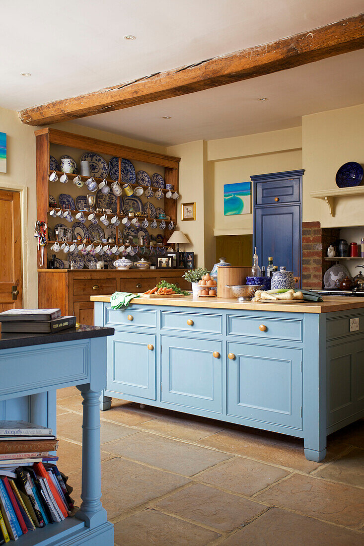 Light blue kitchen island in kitchen of detached Etchingham farmhouse East Sussex England UK