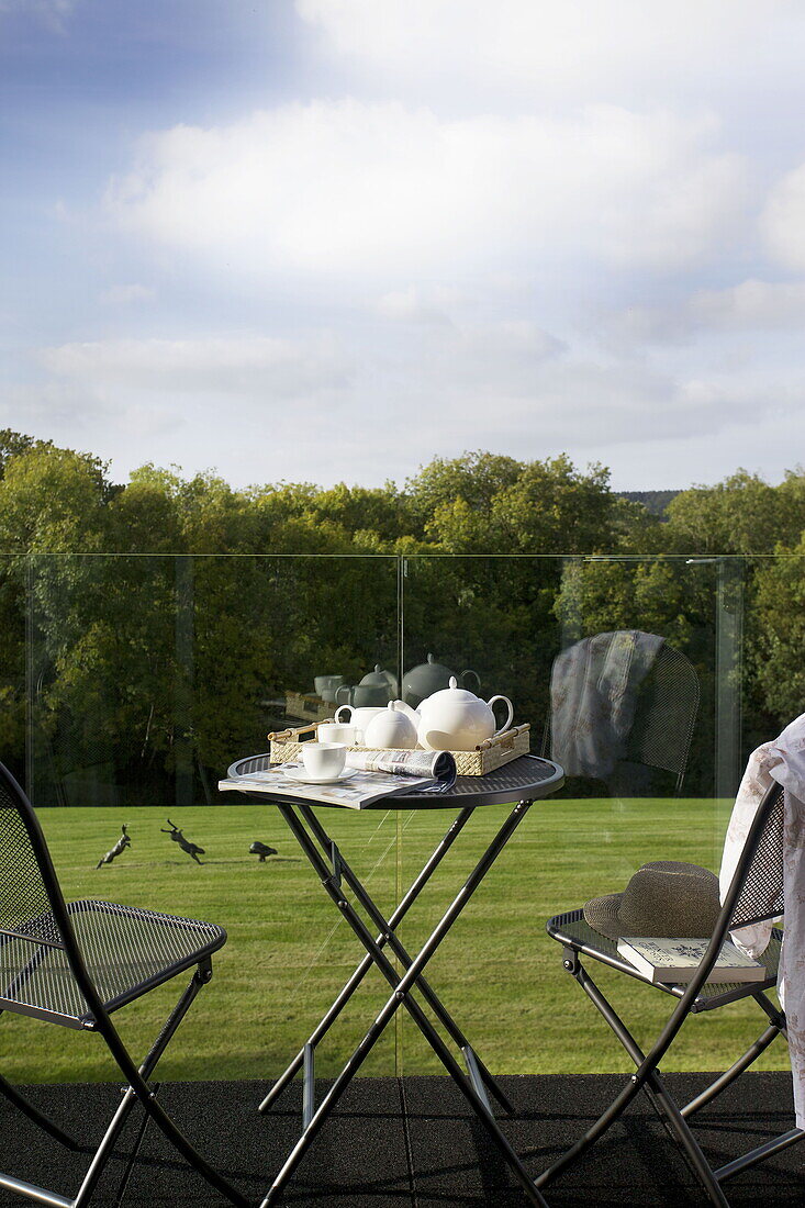 Lawned balcony exterior of contemporary farmhouse in Nuthurst, West Sussex, England, UK