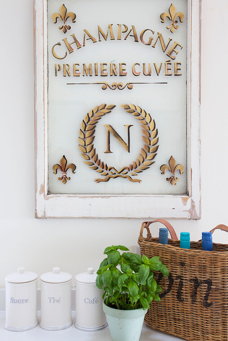 Wine basket and basil with gold embossed champagne log in Dorset cottage Corfe Castle England UK