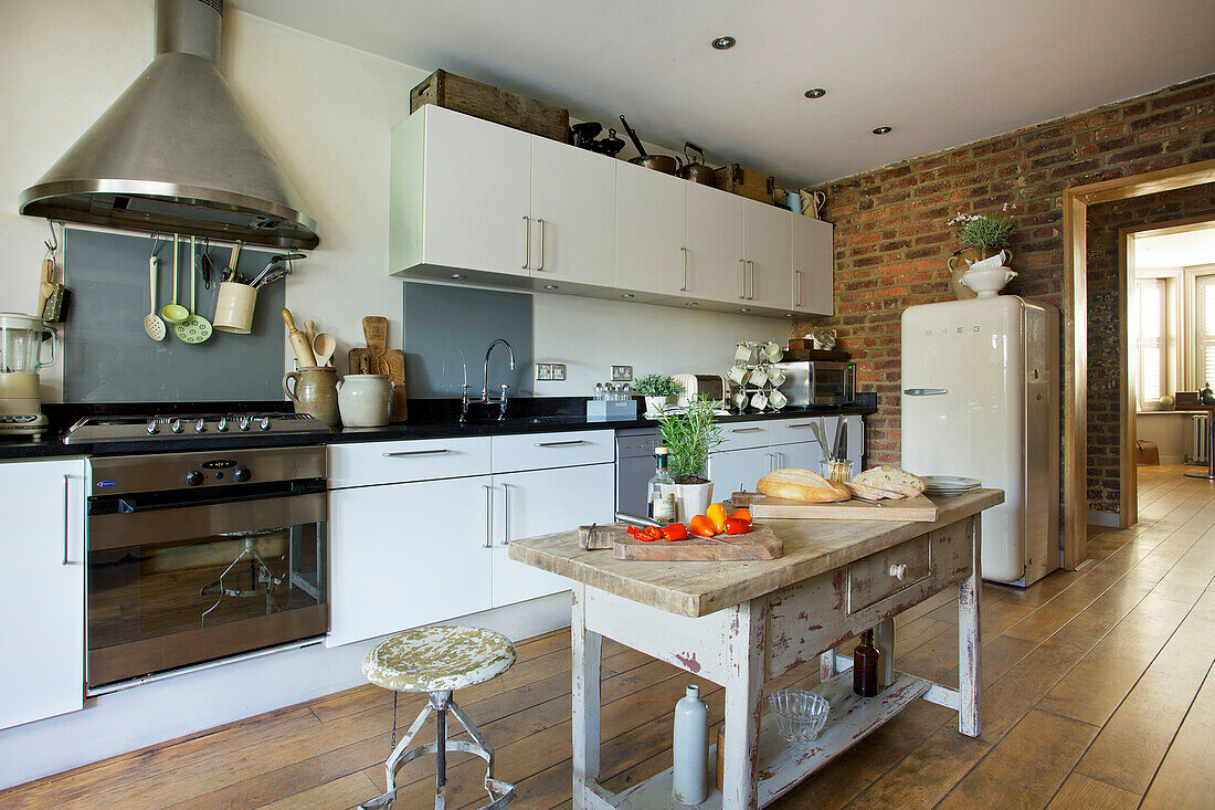 Upright fridge with bread on table in kitchen in Victorian villa Kent England UK