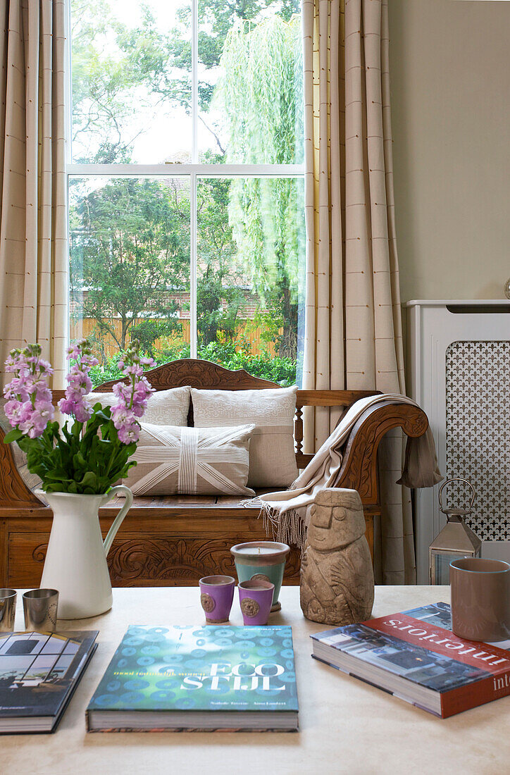 Cut flowers and books on coffee table in Staplehurst living room Kent England UK