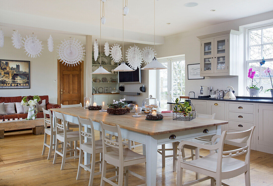 Table with painted chairs in dining room of Faversham home Kent England UK