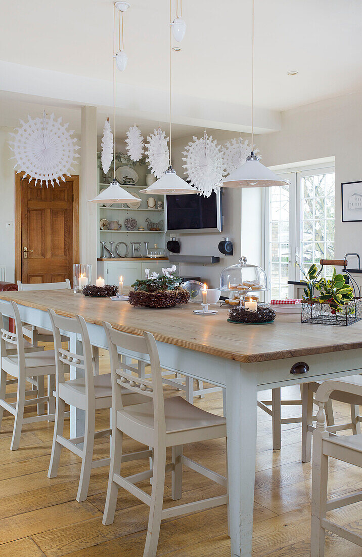 Table with painted chairs in dining room with Christmas decorations in Faversham home Kent England UK