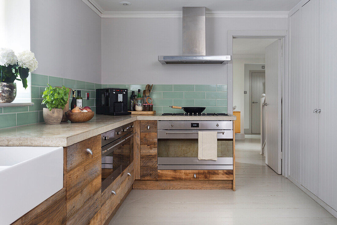 Stainless steel extractor above oven with salvaged wooden drawers in Rye kitchen East Sussex UK