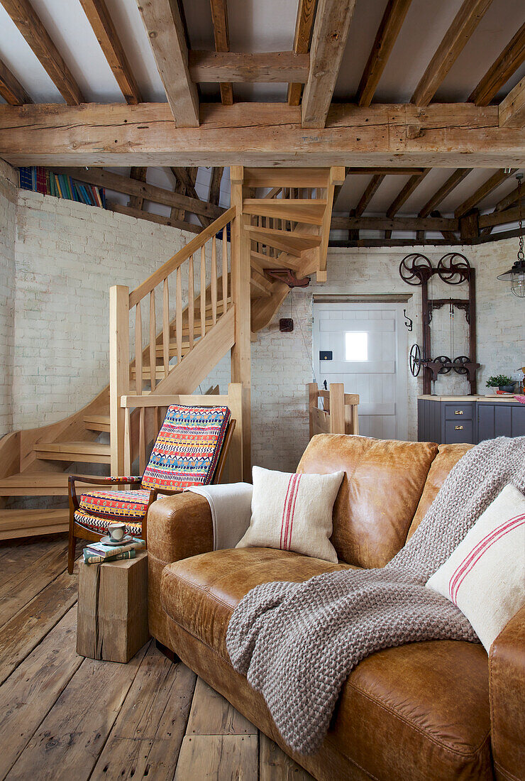 Tan leather sofa in 'meal floor' of Grade ll listed windmill conversion Kent UK